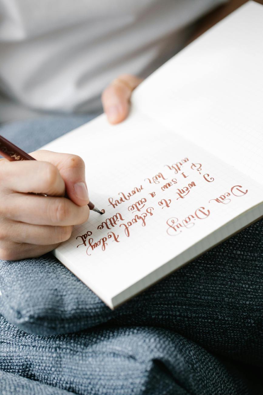 Photo of Writing in Notebook by Katya Wolf on Pexels